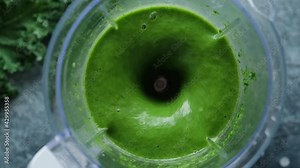 Detox green smoothie blending process. Weight loss, fitness food menu concept. Slow motion mixing green monster smoothie