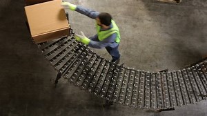 clip-4619918-man-shipping-warehouse-moves-boxes-along-conveyor