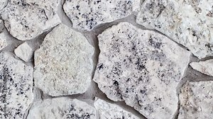 Background, masonry wall of stones of different irregular shapes on cement mortar, rotating, turning, close-up Stock Video