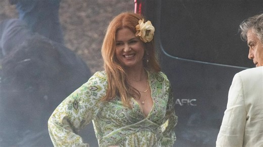 Isla Fisher can't stop smiling as she kisses George Clooney on set of new movie