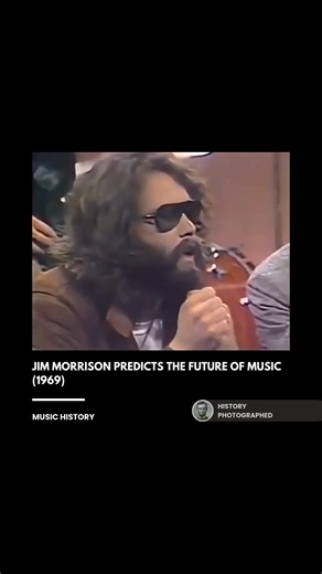 In a 1969 interview, Jim Morrison predicted that future music would shift from traditional rock bands toward heavy reliance on electronics, tapes, and machines. He described a future where a lone artist would use extensive electronic setups to create symphonies, a concept seen as foreshadowing modern electronic music and solo production. Credit: PBS | History In Pictures