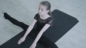 clip-3525611235-young-ballerina-practicing-dance-moves-studio