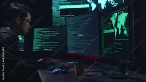 Asian Male Hacker Using Multiple Computer Hacking And Success Downloading Data