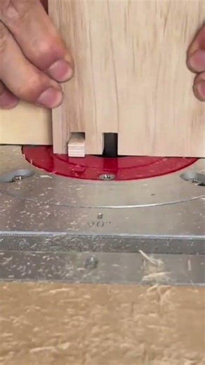 Cutting precise finger joints in a wooden board using a router table for strong furniture assembly