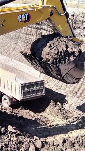 Massive digging power in action! The CAT excavator handles every bucket load