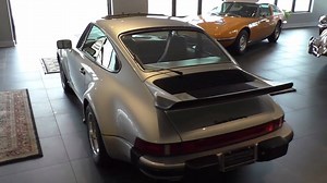 1976 PORSCHE 930 TURBO CARRERA Much of the Porsche 911 Turbo Carrrera's development had resulted from the factory's racing program. The rules for FIA Group 4 homologation required 400 road cars to be built, which spurred the development of 'Project 930' - the legendary 911/930 Turbo. The turbocharged 3.0 liter engine in road trim developed 260bhp with propelled the Turbo Carrera from and standstill to 100 mph in 14 seconds and resulted in a top speed of 155mph. Porsche's first road going super c