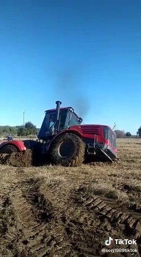 Modern Red Tractor in Action on Rural Fields