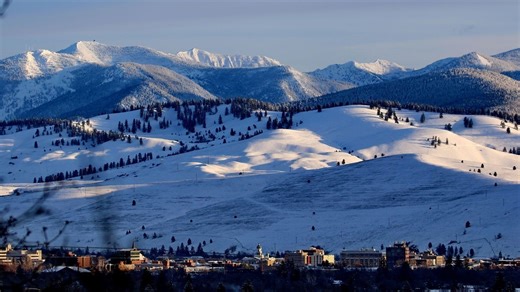 Lingering light snow, spring-like warming trend this week