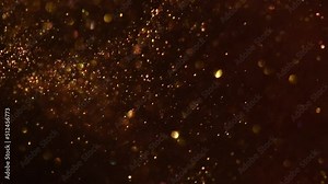 Floating Golden Particles and Bokeh. Real Gold dust particles are smoothly mixed in the liquid. Shining glitter particles are mixed, sparkling and moving randomly. Abstract moving background.