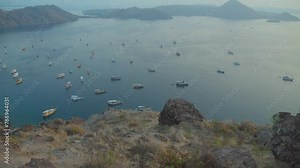 Bay of Padar or Pada island seen from promontory, Indonesia. Tilt-up reveal and sky for copy space