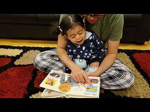 Reading happy baby words book by Roger Priddy.