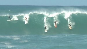 Big-wave surfers hit the Hawaiian water to catch historic swells