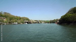 Crossing the river Fowey with views down the estuary showing the large ships and china clay industry docks. Cornwall, England, UK