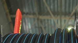 Roll threading coil pipe. Manufacture of plastic water pipes to the factory. Process of making plastic tubes on the machine tool with the use of water and air pressure.