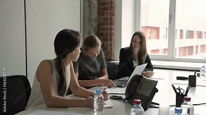 Three business women work in front of laptop after inserting flash card. Female programmer installs new software to update functions and trains employees. Stock Video