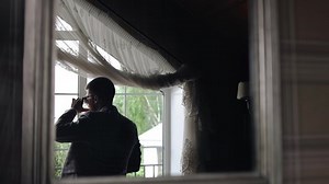 Man Stands Front Window Looking Street Stock Footage Video (100% Royalty-free) 1082091962 | Shutterstock