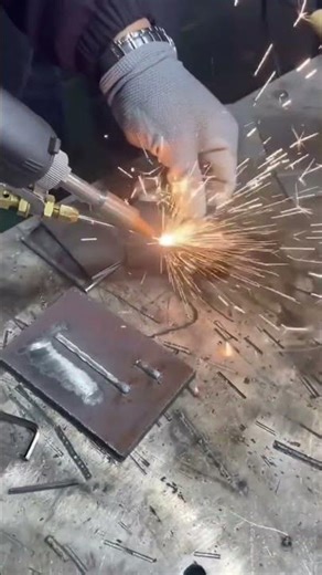 Cutting metal plates using an oxy-acetylene torch generating bright sparks