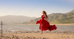 Model on fashion show, aesthetic, modern art. Beautiful young woman in red dress