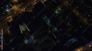 City, traffic at night and street light from a drone pov for travel, transportation or commute with commercial buildings. Cars, road and skyscraper architecture with movement through an urban town