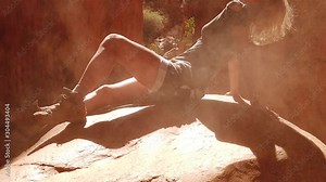 SLOW MOTION: Lifestyle woman sunbathing sitting on a rock inside the canyon of Standley Chasm, Aboriginal Land in West MacDonnell NP. Australian outback Red Center, Northern Territory, Australia.