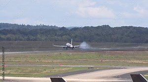 landing generic airplane visible touchdown smoke airport front view intensity aircraft makes contact airplane landing international airport aviation operations runway landing