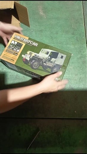 Unboxing a remote-controlled military jeep.