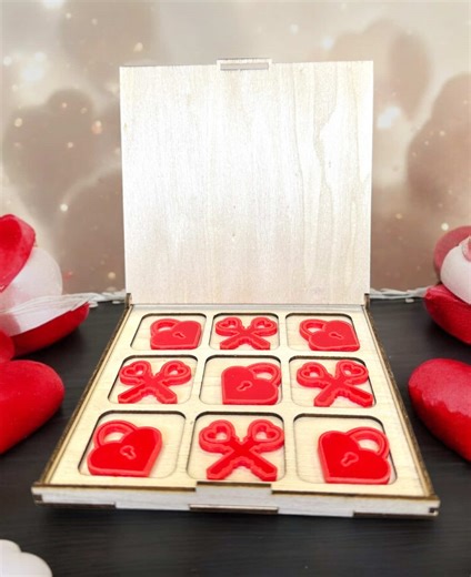 The Perfect and Cute Valentine Game! 💖🔐✨ In this video, HJ Design Studio shows off our beautiful wooden and acrylic Tic Tac Toe game, perfect for Valentine's Day! 💝 This rustic wooden frame and box create a charming and sturdy game set, while the glossy red acrylic game pieces add a pop of color. 🎨❤️ But here's the twist! 😉 Instead of the typical X's and O's, we have adorable heart locks and two crossed heart keys! 🔒🔑💘 This game isn't just fun to play—it's also a stunning gift that can b