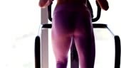 Athletic woman doing exercises on stair stepping machine in the gym.