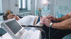 Pregnant woman performing cardiotocography CTG monitoring fetal heartbeat