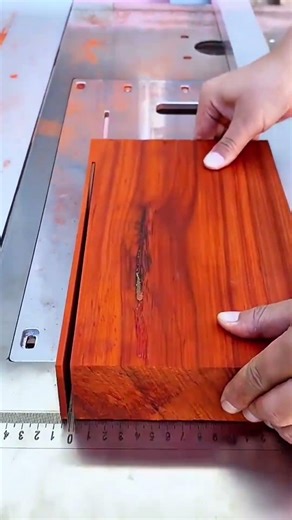 cutting a thick wooden block using a table saw to create a precise slot for woodworking projects now