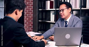 Two Businessman signing contract document start business agreement dealing teamwork. Close up hand young man colleagues meeting mergers and acquisitions business. Partners Signed document at office.