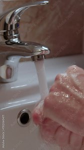 Person practices personal hygiene washing hands hands under water close up vertical video. Personal hygiene vital act helps prevent transmission of harmful bacteria Handwashing is personal hygiene.