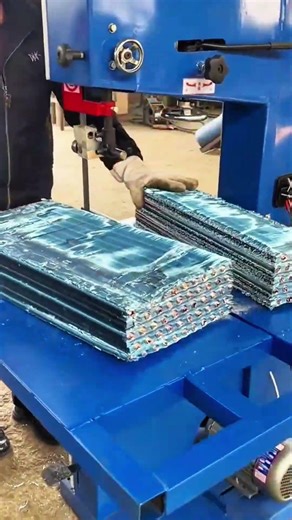 Blade lowers, stack holds, machine slices—laminate parts, edges gleam under steady cut