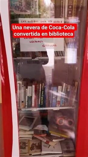 A library inside a Coca-Cola refrigerator