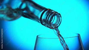 Wine pouring from bottle into glass blue (azure) background close up shot. Slow motion, macro. Liquid, hard alcohol
