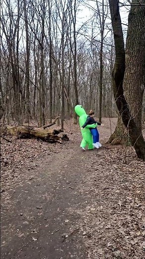 Woman wearing an inflatable alien costume looks like she's being carried away!