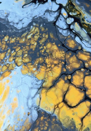 Buried Alchemy explores transformation under pressure — the slow, unseen process where heat, time, and weight turn raw matter into something precious. A restrained palette of black, graphite, and silver forms a layered, stone-like foundation, fractured and illuminated by veins of metallic gold that move through the surface like hidden seams beneath the earth. Organic cells, crackled textures, and flowing striations echo geological formations shaped over time. The gold is not decorative but struc