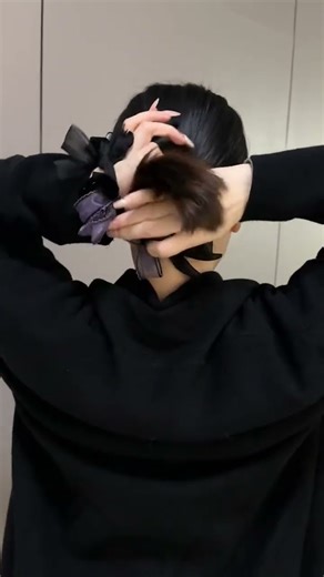 Learn how to create a low bun in winter with this slow-motion tutorial.