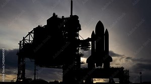 The US Space Shuttle: Time Lapse at Sunrise with Fast Clouds and Dark Silhouette of Spacecraft