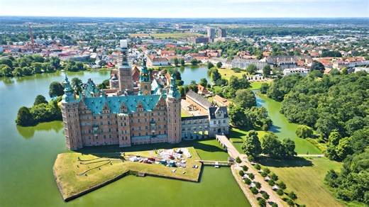A renaissance castle surrounded by lakes