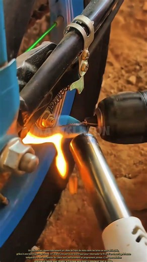 Un mécanicien répare un câble de frein effiloché grâce à une technique ingénieuse.