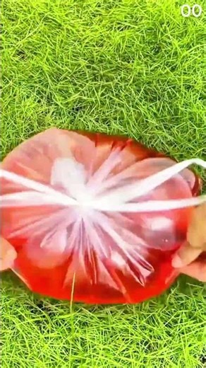 Hand peels plastic sheet from red gelatin heart mold