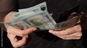 Counting US currency. Woman counts money. New dollars in hand. Slow motion. HD