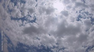 Blue sky and puffy clouds in day time. Round puffy clouds slowly move vatical in clear clear sky. Beautiful clouds, clean atmosphere, summer time footage.