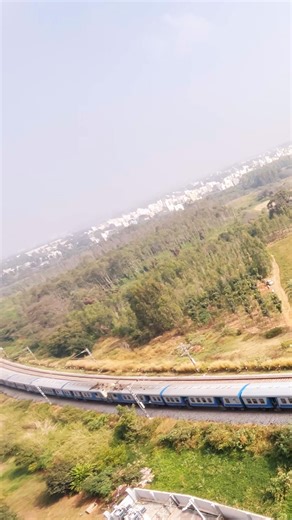 Double engine local train moving past the locality