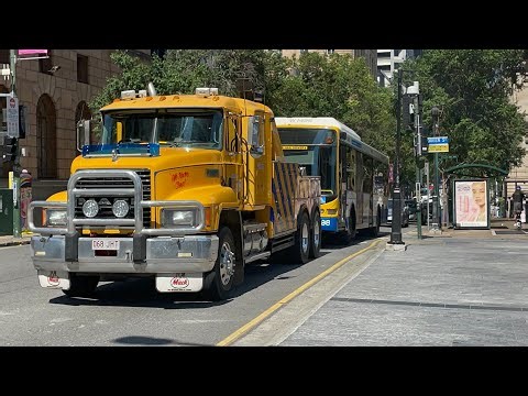 A bus getting towed by a tow truck in Brisbane