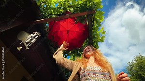 beautiful girl dancing under an umbrella on a beautiful sunny day.