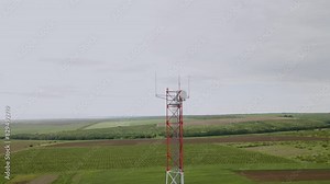 Image from above with the drone at a tall telecommunications construction. Construction of transmission towers for telecommunications. Aerial view of a telecommunications network