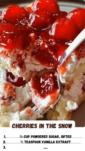 Cherries in the Snow is a dreamy layered dessert with soft ladyfingers and a fluffy cheesecake and marshmallow filling, all topped with sweet cherry pie filling. It's incredibly easy to make and perfect for any potluck or holiday! | Recipes all time