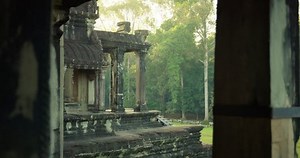 Angkor Wat temple entrance in bright early sunrise sunlight; reveal